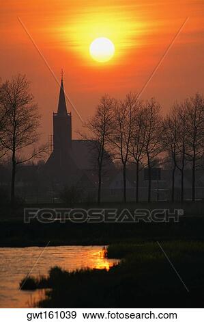 Silhouette of a church at dawn, Schermer, Netherlands View Large Photo Image Stock Photo - Silhouette of a church at dawn, Schermer, Netherlands. Fotosearch