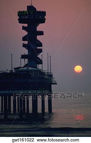 Stock Image - Silhouette of a tower on a pier, Netherlands. Fotosearch
