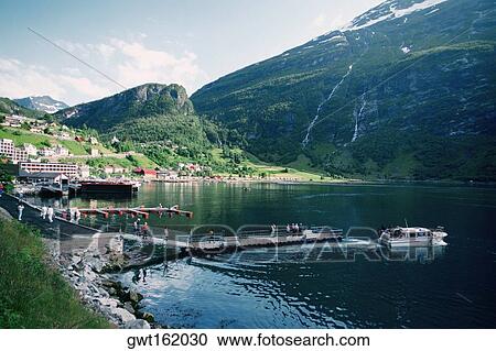 Stock Image - Group of people at a pier, Geiranger, Norway. Fotosearch