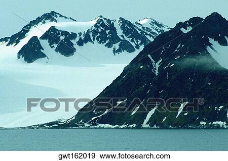 Snowcapped mountains at the waterfront, Svalbard islands, Norway View Large Photo Image Stock Photo - Snowcapped mountains at the waterfront, Svalbard islands, Norway. Fotosearch