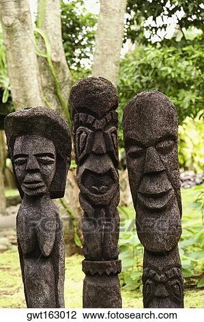 Stock Image - Close-up of carved stone statues, Fiji. Fotosearch