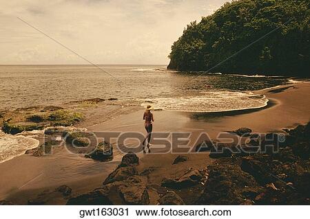 High angle view of a woman running on the beach, Tahiti, Society Islands, French Polynesia View Large Photo Image Stock Image - High angle view of a woman running on the beach, Tahiti, Society Islands, French Polynesia. Fotosearch