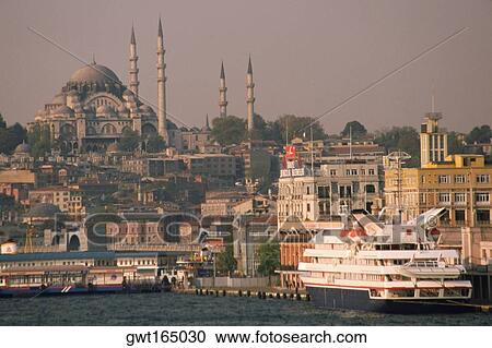Stock Image - Cruise ship docked at the harbor with a mosque in the background, Suleymanie Mosque, Golden Horn, Istanbul, Turkey. Fotosearch