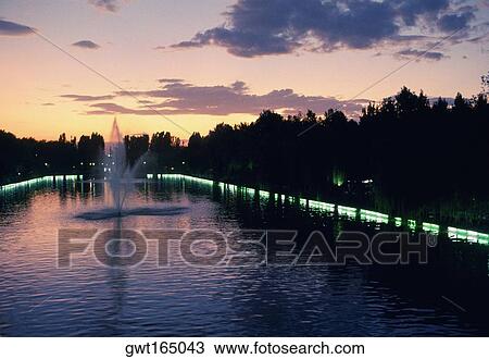 Stock Image - Fountain in a pond at dusk, Istanbul, Turkey. Fotosearch