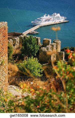 High angle view of a fort with a cruise ship docked near a jetty, Alanya, Turkey View Large Photo Image Stock Photo - High angle view of a fort with a cruise ship docked near a jetty, Alanya, Turkey. Fotosearch
