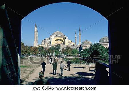 Stock Photography - Rear view of tourist walking towards a mosque, Blue Mosque, Istanbul, Turkey. Fotosearch