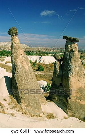 Rock formations on a landscape, Fairy Chimneys, Cappadocia, Turkey View Large Photo Image Stock Image - Rock formations on a landscape, Fairy Chimneys, Cappadocia, Turkey. Fotosearch
