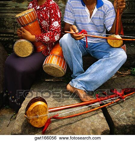 Close-up of two musicians at a temple, Ta Prohm Temple, Angkor, Siem Reap, Cambodia View Large Photo Image Stock Photograph - Close-up of two musicians at a temple, Ta Prohm Temple, Angkor, Siem Reap, Cambodia. Fotosearch