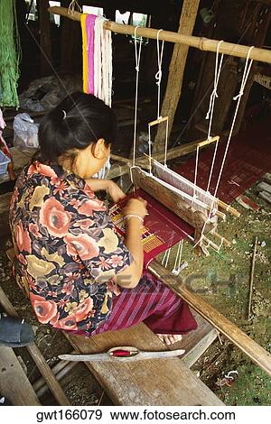 High angle view of a young woman weaving on traditional loom, Sukhothai, Thailand View Large Photo Image Stock Photo - High angle view of a young woman weaving on traditional loom, Sukhothai, Thailand. Fotosearch