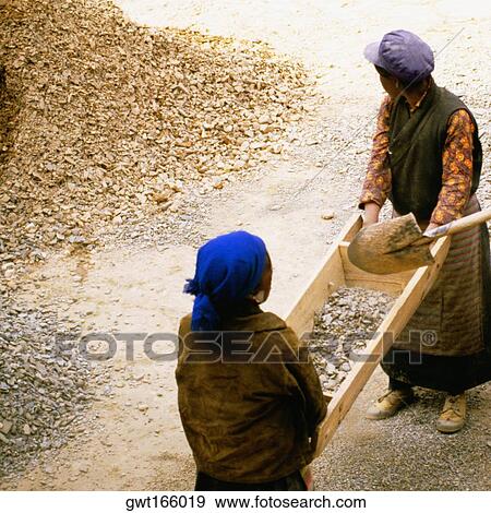 High angle view of two female manual workers carrying a wooden container, Yarlung Valley, Tibet, China View Large Photo Image Stock Photo - High angle view of two female manual workers carrying a wooden container, Yarlung Valley, Tibet, China. Fotosearch