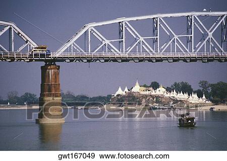 Stock Photo - Bridge across a river with a pagoda in the background, Ava bridge, Shwe Kyet Yet Pagoda, Ayeyarwady River, Mandalay, Myanmar. Fotosearch