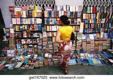 Rear view of a woman standing at bookstall, Yangon, Myanmar View Large Photo Image Stock Photography - Rear view of a woman standing at bookstall, Yangon, Myanmar. Fotosearch