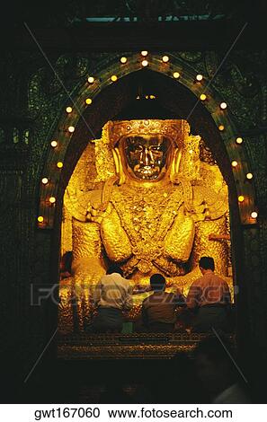 Rear view of three men praying in front of a statue of Buddha, Mandalay, Myanmar View Large Photo Image Stock Image - Rear view of three men praying in front of a statue of Buddha, Mandalay, Myanmar. Fotosearch