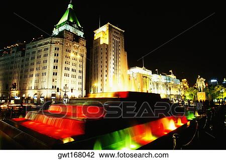 Buildings and fountains lit up at night, The Bund, Shanghai, China View Large Photo Image Stock Image - Buildings and fountains lit up at night, The Bund, Shanghai, China. Fotosearch