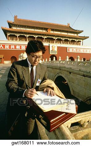 Businessman standing in front of a palace and writing with a pen on a sheet of paper, Tiananmen Gate Of Heavenly Peace, Tiananmen Square, Beijing, China View Large Photo Image Stock Image - Businessman standing in front of a palace and writing with a pen on a sheet of paper, Tiananmen Gate Of Heavenly Peace, Tiananmen Square, Beijing, China. Fotosearch