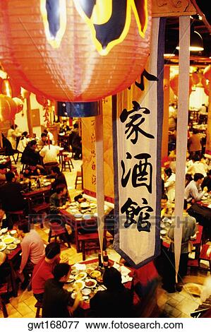 Stock Photo - High angle view of a group of people in a restaurant, Nanjing, Jiangsu Province, China. Fotosearch