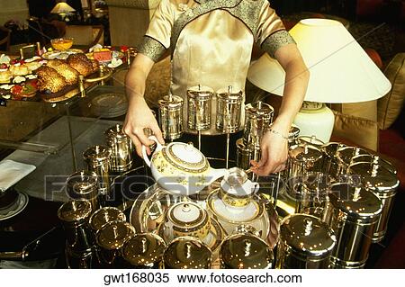 Mid section view of a waitress pouring tea in tea cups, Pudong Shangri-La, Shanghai, China View Large Photo Image Stock Photography - Mid section view of a waitress pouring tea in tea cups, Pudong Shangri-La, Shanghai, China. Fotosearch