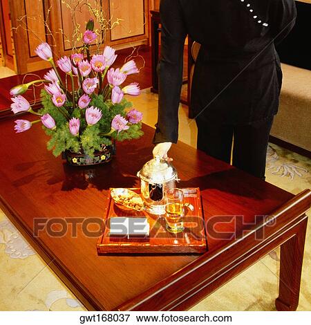 Mid section view of a woman serving tea, Pudong, Shanghai, China View Large Photo Image Stock Photo - Mid section view of a woman serving tea, Pudong, Shanghai, China. Fotosearch