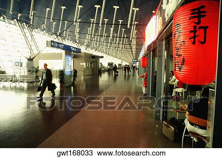 Passengers in an airport, Pudong, Shanghai, China View Large Photo Image Stock Image - Passengers in an airport, Pudong, Shanghai, China. Fotosearch
