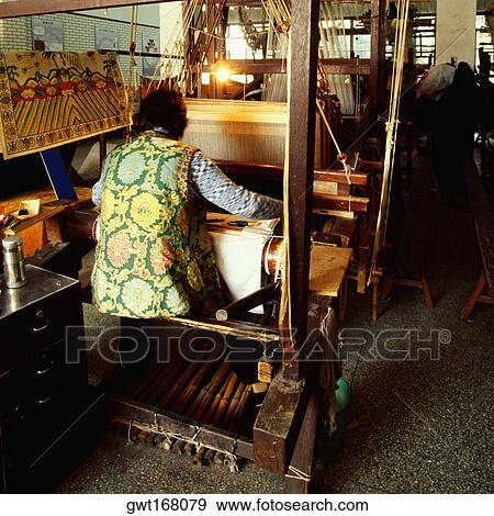 Rear view of a person weaving silk on a loom, Nanjing, Jiangsu Province, China View Large Photo Image Stock Photo - Rear view of a person weaving silk on a loom, Nanjing, Jiangsu Province, China. Fotosearch