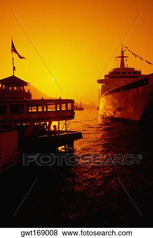 Cruise ship and a tourboat at a harbor, Hong Kong, China View Large Photo Image Stock Photo - Cruise ship and a tourboat at a harbor, Hong Kong, China. Fotosearch