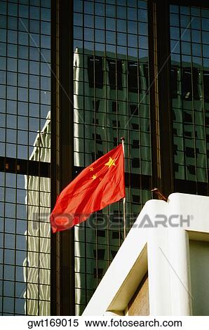 Stock Photography - Low angle view of a Chinese Flag on a building, Hong Kong, China. Fotosearch