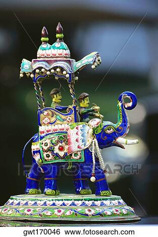 Stock Photograph - Close-up of a figurine of two men on an elephant, Jaipur, Rajasthan, India. Fotosearch