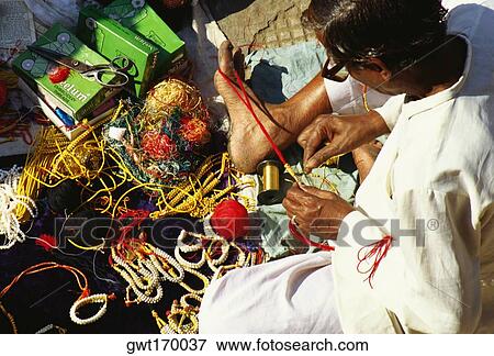 High angle view of a mature man making bracelets, Jaipur, Rajasthan, India View Large Photo Image Stock Photo - High angle view of a mature man making bracelets, Jaipur, Rajasthan, India. Fotosearch