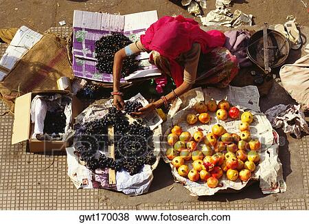 High angle view of a woman selling fruits, Jaipur, Rajasthan, India View Large Photo Image Stock Photo - High angle view of a woman selling fruits, Jaipur, Rajasthan, India. Fotosearch