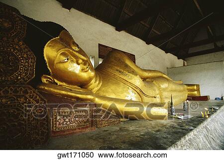 Close-up of a statue of reclining Buddha in a temple, Chiang Mai, Bangkok, Thailand View Large Photo Image Stock Image - Close-up of a statue of reclining Buddha in a temple, Chiang Mai, Bangkok, Thailand. Fotosearch