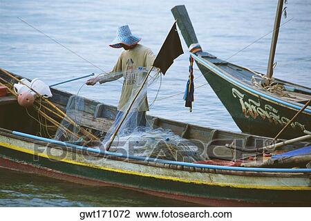 Fisherman standing on a fishing boat, Koh Samui, Thailand View Large Photo Image Stock Image - Fisherman standing on a fishing boat, Koh Samui, Thailand. Fotosearch