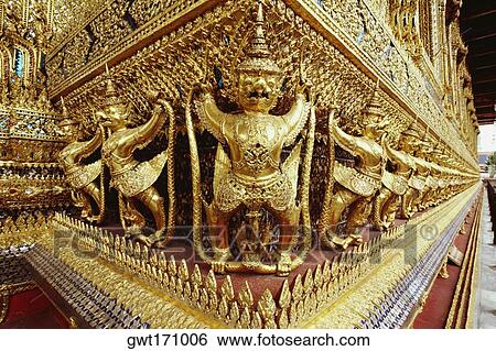 Golden statues carved on walls of a temple, Wat Phra Kaeo, Bangkok, Thailand View Large Photo Image Stock Photograph - Golden statues carved on walls of a temple, Wat Phra Kaeo, Bangkok, Thailand. Fotosearch