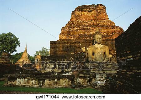 Picture - Old ruins of a statue of Buddha at a temple, Si Satchanalai Historical Park, Sukhothai, Thailand. Fotosearch