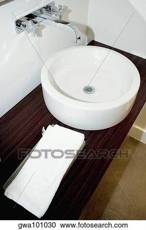 Stock Image - High angle view of a towel near a bathroom sink. Fotosearch
