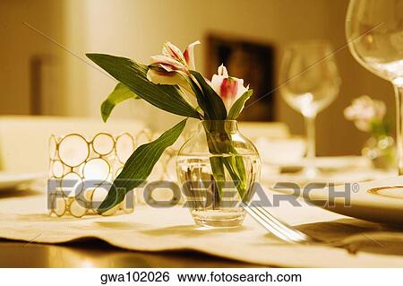Close-up of a flower vase with candlestick holders on a dining table View Large Photo Image Stock Photograph - Close-up of a flower vase with candlestick holders on a dining table. Fotosearch