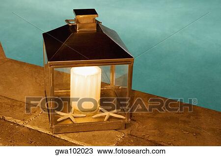 Close-up of a lantern at the poolside View Large Photo Image Stock Image - Close-up of a lantern at the poolside. Fotosearch