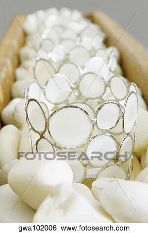 Close-up of decorative glasses on pebbles View Large Photo Image Stock Photograph - Close-up of decorative glasses on pebbles. Fotosearch