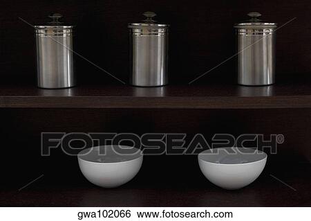 Stock Photograph - Close-up of kitchen utensil in shelves. Fotosearch