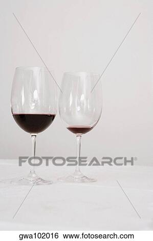 Close-up of two wine glasses on a dining table View Large Photo Image Stock Photograph - Close-up of two wine glasses on a dining table. Fotosearch