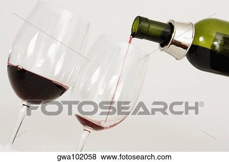 Close-up of wine being poured into wine glasses View Large Photo Image Stock Photo - Close-up of wine being poured into wine glasses. Fotosearch
