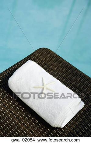 High angle view of a starfish with a towel on a lounge chair at the poolside View Large Photo Image Picture - High angle view of a starfish with a towel on a lounge chair at the poolside. Fotosearch
