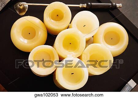 Stock Image - High angle view of candles with a bell in a tray. Fotosearch