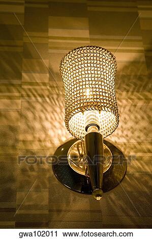 Low angle view of a lamp lit up at night View Large Photo Image Stock Image - Low angle view of a lamp lit up at night. Fotosearch