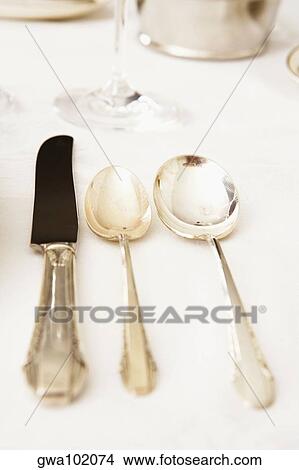 Table knife with two spoons on a dining table View Large Photo Image Picture - Table knife with two spoons on a dining table. Fotosearch