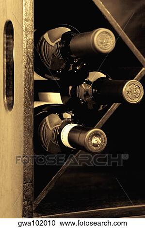 Wine bottles in a wine rack View Large Photo Image Stock Image - Wine bottles in a wine rack. Fotosearch