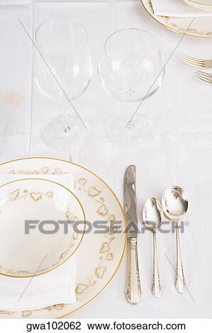 Wine glasses with plates and cutleries on a dining table View Large Photo Image Stock Image - Wine glasses with plates and cutleries on a dining table. Fotosearch