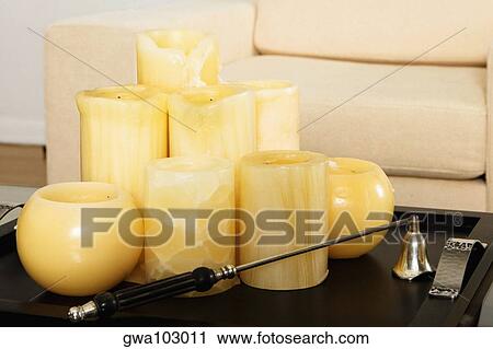 Stock Image - Candles in a tray on a coffee table. Fotosearch