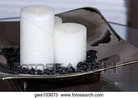 Close-up of candles and pebbles in a tray View Large Photo Image Stock Photography - Close-up of candles and pebbles in a tray. Fotosearch