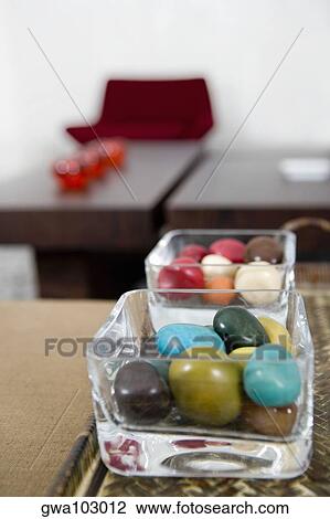 Stock Image - Close-up of colored stones in two bowls. Fotosearch