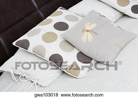 Stock Photo - Close-up of cushions and pillows on the bed. Fotosearch